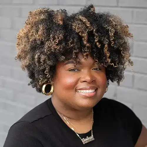 Portrait of Courtenay, a professional stylist at Salon Ciseaux, showcasing their expertise and style.