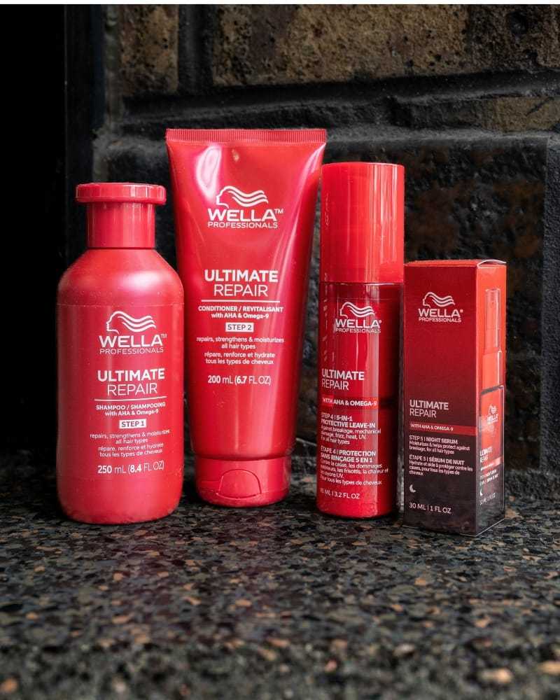 Wella Ultimate Repair products on a shelf, including shampoo, conditioner, serum, and more.